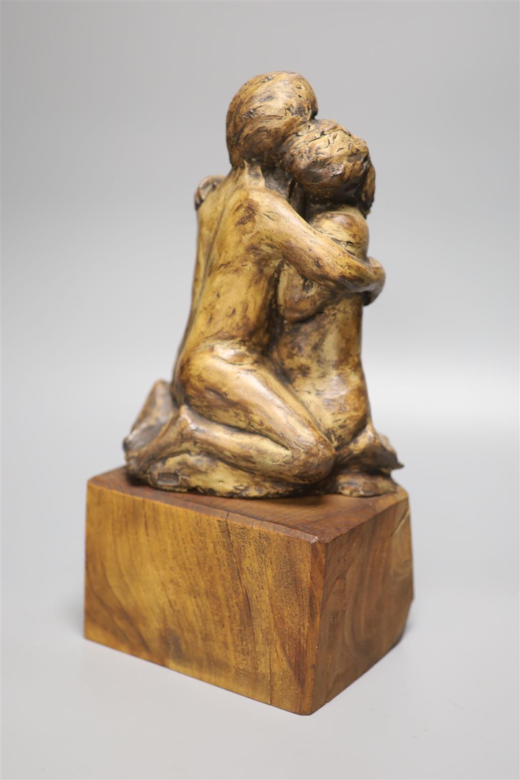 A resin sculpture of lovers on hardwood base, stamped to reverse PHD, height 34cm